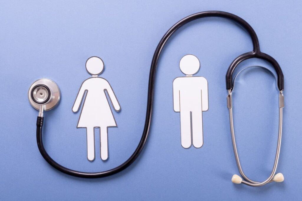 Paper cutouts of a woman and a man stand side by side on a blue background, with a stethoscope positioned in a loop beside them.