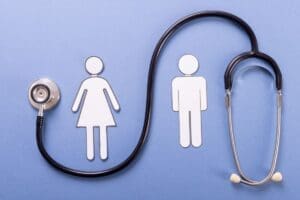 Paper cutouts of a woman and a man stand side by side on a blue background, with a stethoscope positioned in a loop beside them.